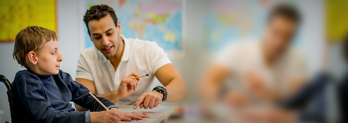 Teacher helping a boy