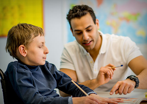 Teacher helping a boy