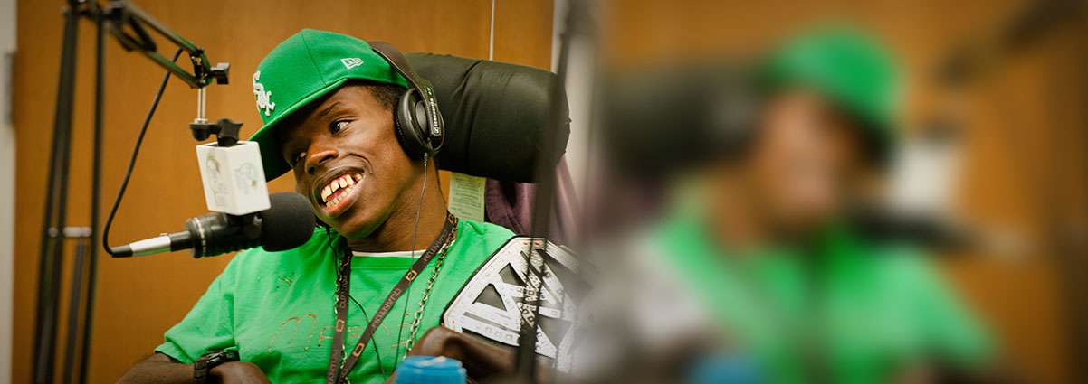 Young man with headphone talking in to a microphone