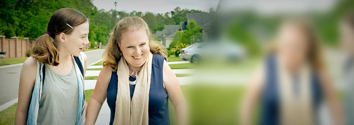 Young girl and woman talking and laughing