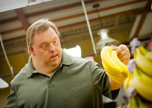 Man picking up bananas at market