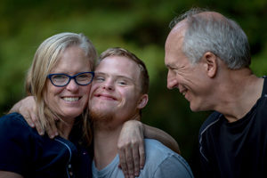 ABLE family hugging and smiling