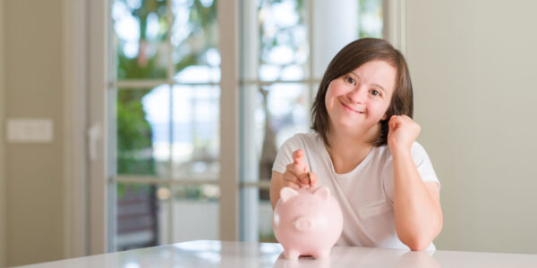 Girl putting money in a piggy bank
