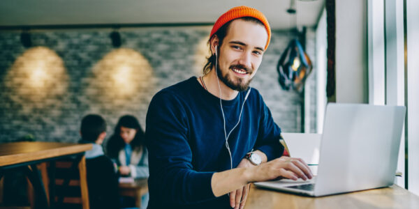 Hipster man on his computer at a cafe