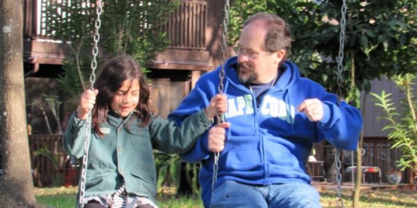 Travis Foster with grand daughter on swings