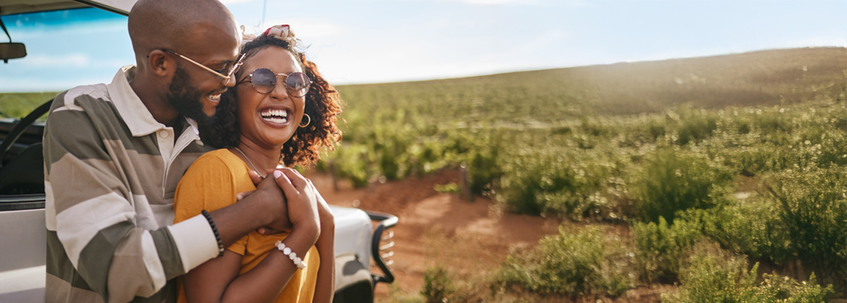 Couple smiling and laughing outside in the sun