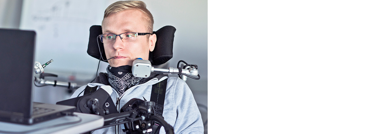 Man using mouth-based assistive technology for his computer