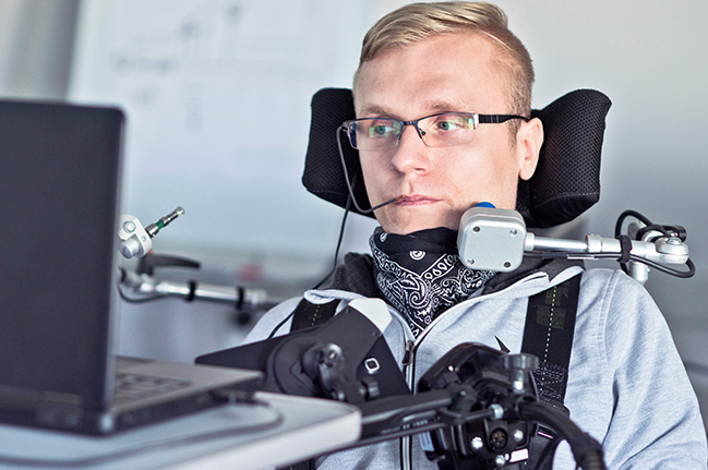 Man using mouth-based assistive technology for his computer