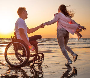 man in a wheelchair with his family