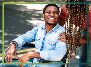 man smiling in a wheelchair