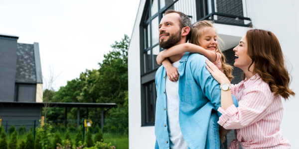 Man smiling and looking hopeful with his family beside him