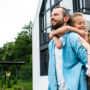Man smiling and looking hopeful with his family beside him