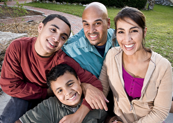 Hispanic family sitting together in a circle and looking up at the camera