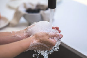 Hands being washed in a sink