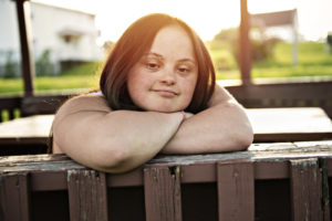 Woman on fence sunset