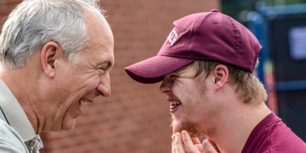 ABLE Account holder laughing and smiling with caregiver